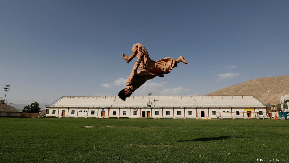 Syed Raza Hazara, 18, back flips as he performs Parkour at the Qayum Papa Stadium in Mariabad, Quetta, Pakistan (photo: Reuters/A. Soomro)