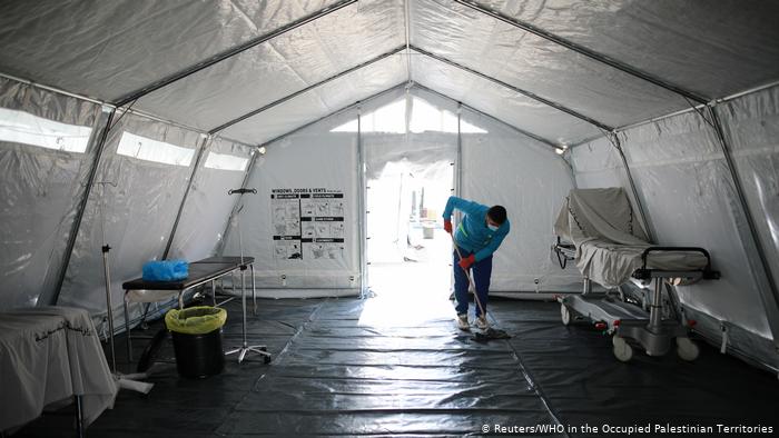 A worker mops the floor at a quarantine facility set up at the Rafah border crossing (photo: Reuters/WHO in the Occupied Palestinian Territories)