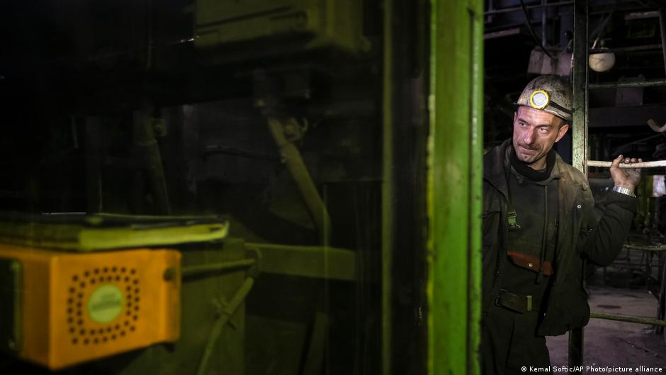 A Bosnian coal miner checks equipment in an underground tunnel at a mine in Zenica, Bosnia, 29 April 2021 (photo: AP Photo/Kemal Softic)