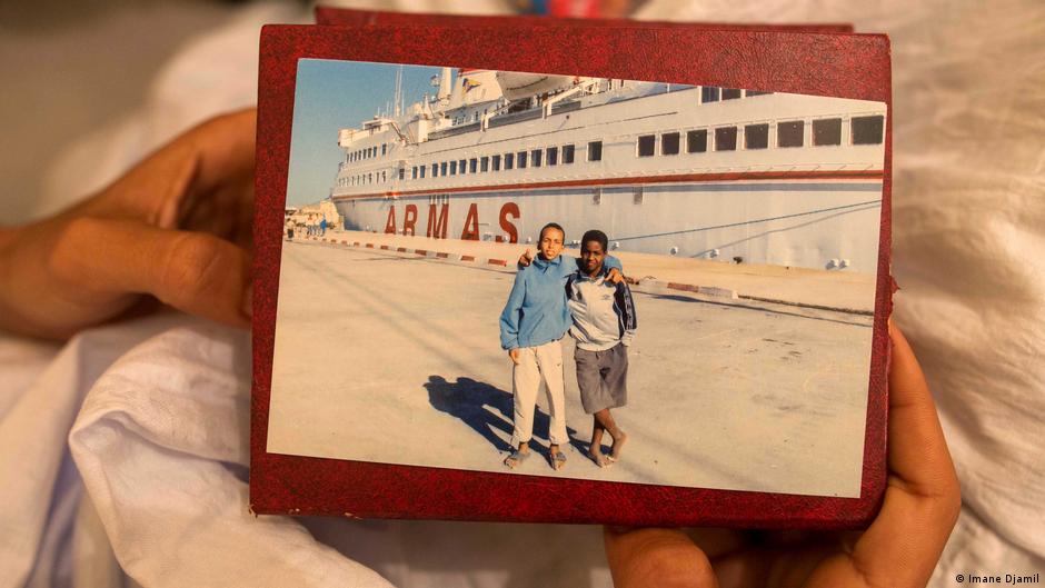 Maatoug holds a photo taken in 2008 of himself and a friend posing in front of The Armas Essalama (photo: Imane Djamil)