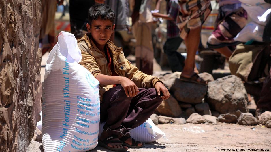 Yemeni boy sits with a sack of wheat flour, an essential aid handout in war-torn Yemen (photo: Ahmad Al-Basha/AFP/Getty Images)