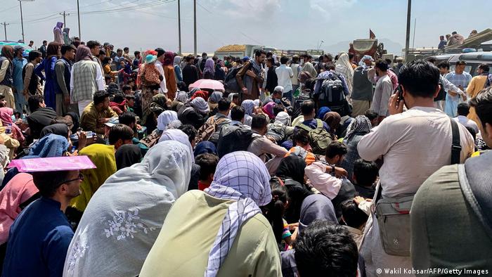 Crowds line the road to Kabul airport