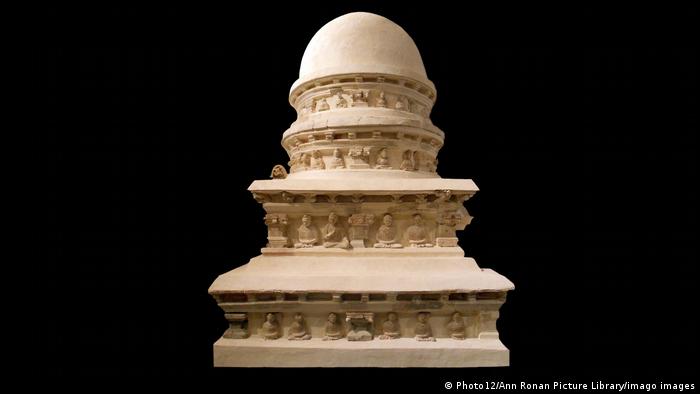 A Buddhist stupa with figures under its multiple eaves