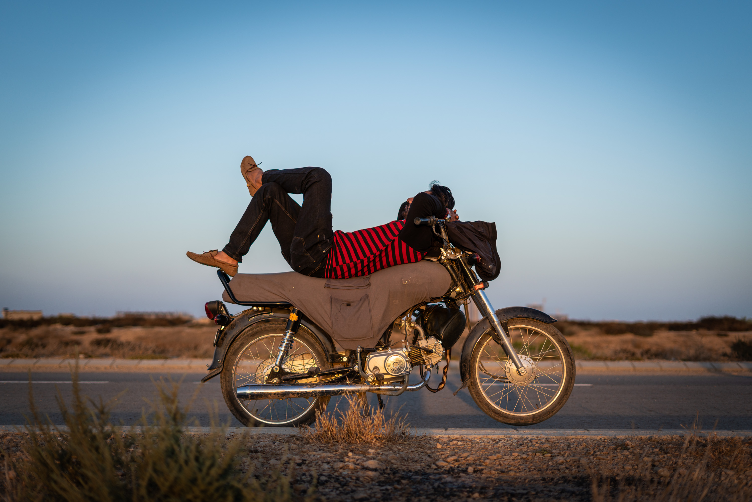 Einer der Fahrlehrer der Pink Riders macht eine Pause auf seinem Bike in Karachi, Pakistan (photo: Philipp Breu)