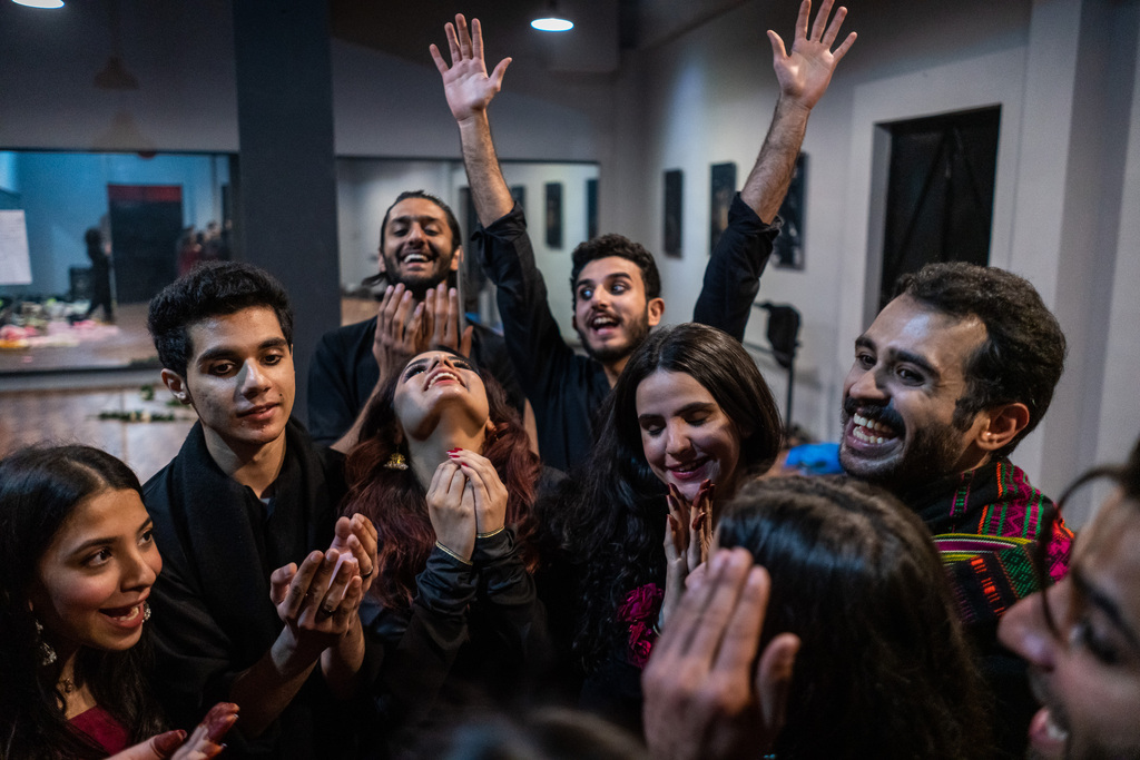 Performers pray together before a show begins at The Colony, Lahore, Pakistan (photo: Philip Breu)