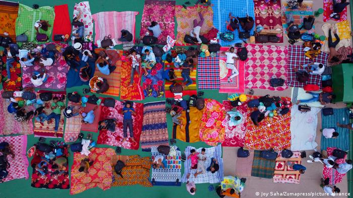 Blankets spread on the roof of a ferry with people lying on them