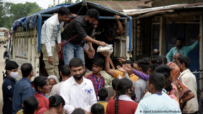 Volunteers distribute food to affected people