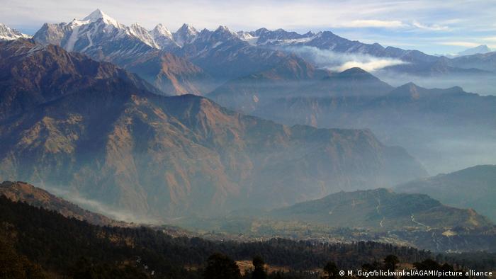 The long Himalayas mountain range that is slightly overcast. In the background there are many white mountain peaks