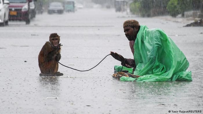 A man asks for alms with his monkey in Hyderabad