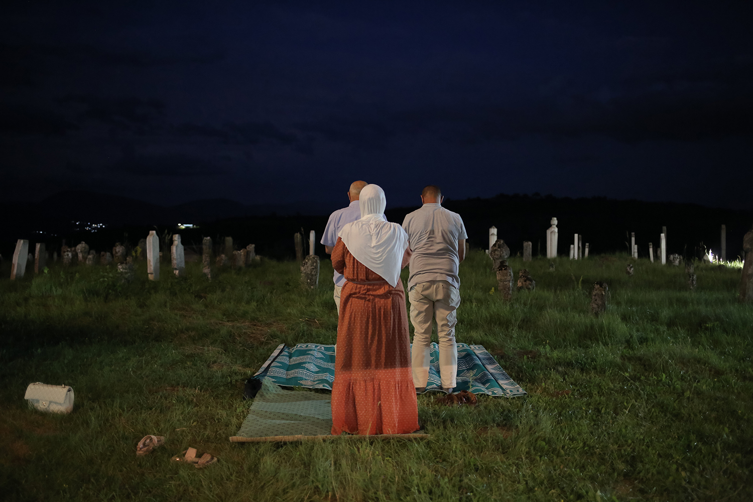 A family at prayer in an old cemetery (photo: Konstantin Novakovic)