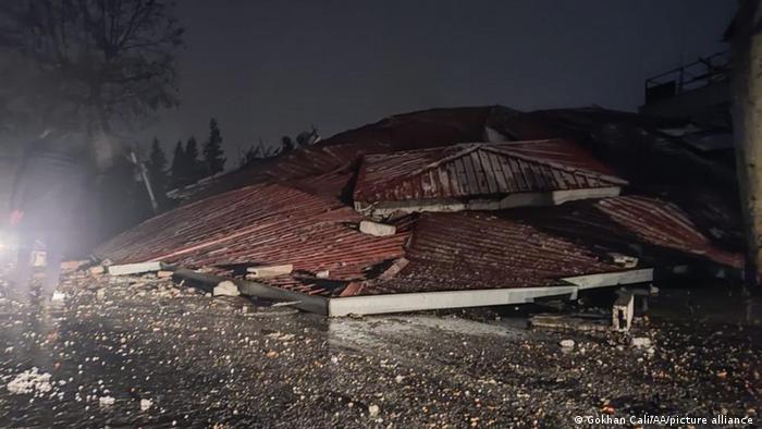 The rubble of the house is buried under its own roof