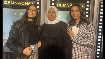 Main title: (The story of Olfa's Daughters)   Photo's title: (Olfa and her two Daughters in the premiere of the Tunisian movie Olfa's Daughters at the cinema of the Kulturbrauerei-Cinestar, Berlin Hall) Place & Date: (Berlin –18th Jan 2024) - Copyright / Photographer: Copyright for Qantara, Mohammed Magdy