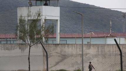 Exterior view of a prison in Turkey. A guard is on patrol.