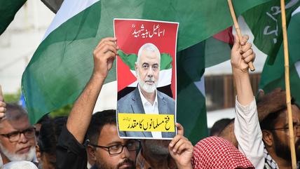 Menschen halten am 31. Juli 2024 in Karachi, Pakistan, ein Bild des getöteten Führers der Hamas, Ismail Haniyeh, in die Höhe.