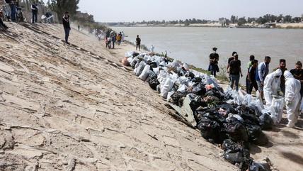 Young Iraqi volunteers take part in a cleanup campaign on the banks of the Tigris River, a rare environmental project in the war-battered country.