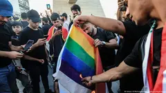  Supporters of the Popular Mobilisation Forces burn a rainbow flag during a protest in Tahrir Square in Baghdad
