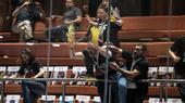 Israeli protesters demand the return of Hamas-held hostages, smearing yellow paint on the windows of Israel's parliament in early April 