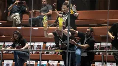 Israeli protesters demand the return of Hamas-held hostages, smearing yellow paint on the windows of Israel's parliament in early April 