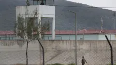 Exterior view of a prison in Turkey. A guard is on patrol.