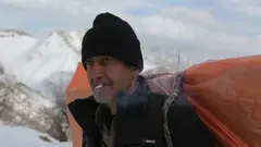 After a short cigarette break, a fully laden kolbar sets out on the final leg of the journey. Exposure to the mercy of the elements is not the only risk for kolbars, who are regularly monitored and frequently shot at by Iranian border patrol officers 